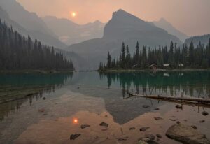 A picture of a lake with a cloudy sunset in the background. BC has changed its PNP points allocation.