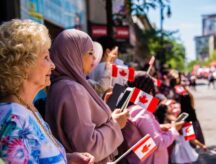 A group of people celebrating Canada Day on the streets of Toronto