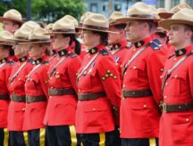 A group of RCMP officers in line at a ceremony