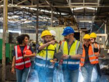 A group of construction workers conversing throughout a work site.