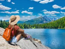 young woman relaxing by a lake in Canada's Rocky Mountains.