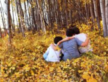 A group of boys in the woods, enjoying the fall weather