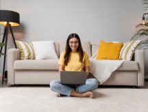 A person siting in the living room, preparing for a virtual interview online.