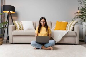 A person siting in the living room, preparing for a virtual interview online.