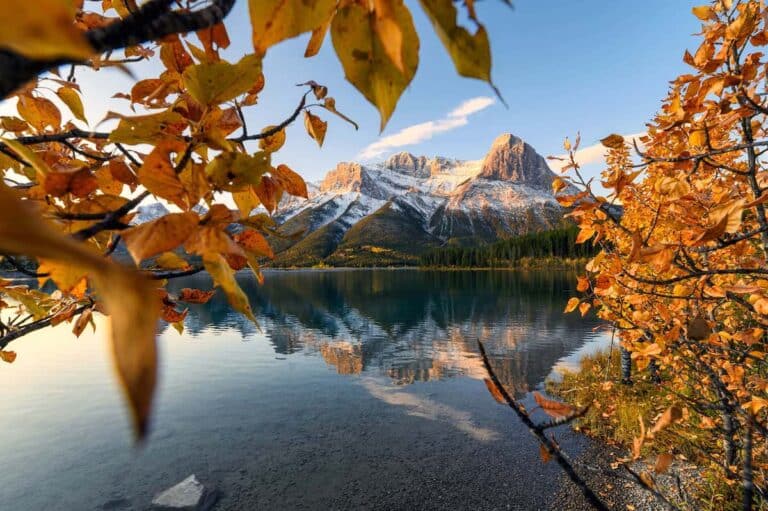 A view of a mountain through fall leaves.