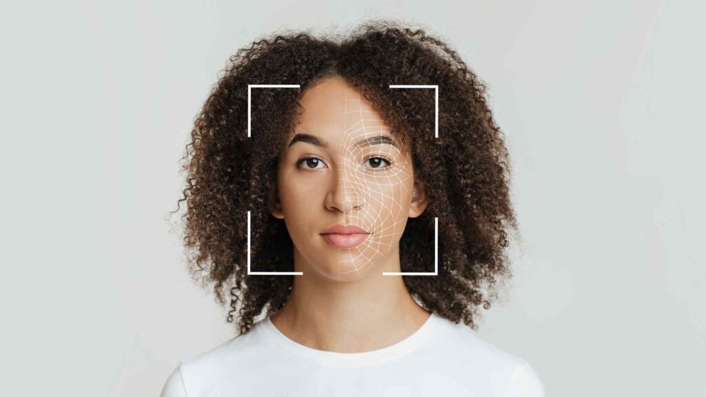 Picture of a woman in the viewfinder of a camera, with a scanner projected onto her face.