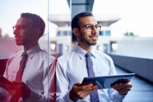 Picture of a man smiling and holding a tablet