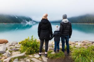 Family stares out over a lake