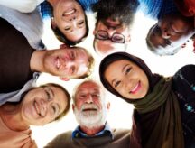 Diverse people looking down at the camera