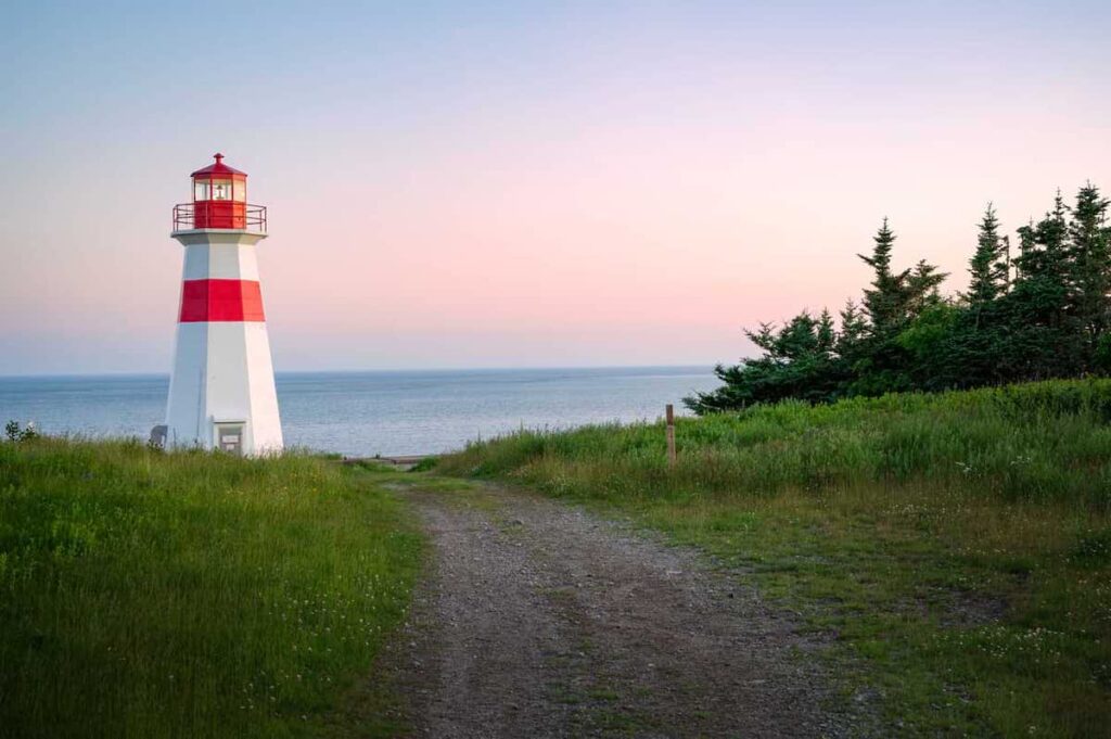 A picture of a lighthouse on the New Brunswick coast during a sunset.