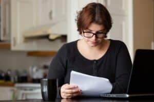 Woman stares at paperwork.