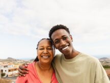 A picture of a man and his mother smiling.