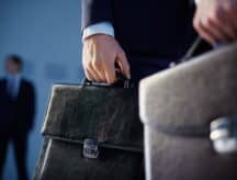 A hand holding a briefcase