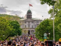 A mass of students in front of a building on Quebec's McGill University campus