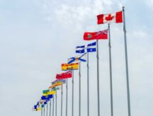 A row of Canada's provincial and national flags blowing in the wind