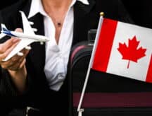 A woman in business attire holds a Canadian flag and a toy airplane