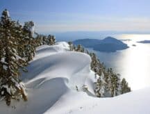 A view of the lake from snow capped mountains in British Columbia