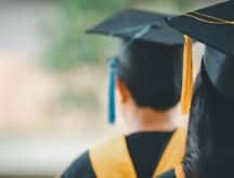 the back of the head of a recent graduate, on the way to his graduation ceremony