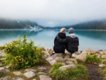 A couple sitting at a lake in Banff national park.