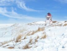 A lighthouse covered in snow on the Canadian coast.