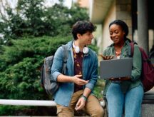 Two students conversing on a university campus