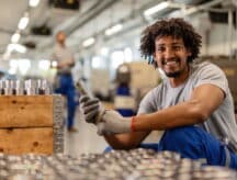 A worker in Alberta is happy packing machine parts, knowing that he can apply for an open work permit under the latest public policy.