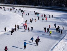 A group of people skating on an ice track in Ottawa.